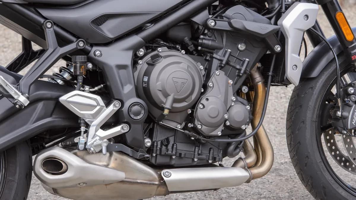 Close-up of Triumph Trident 660 660cc triple-cylinder engine with metallic detailing