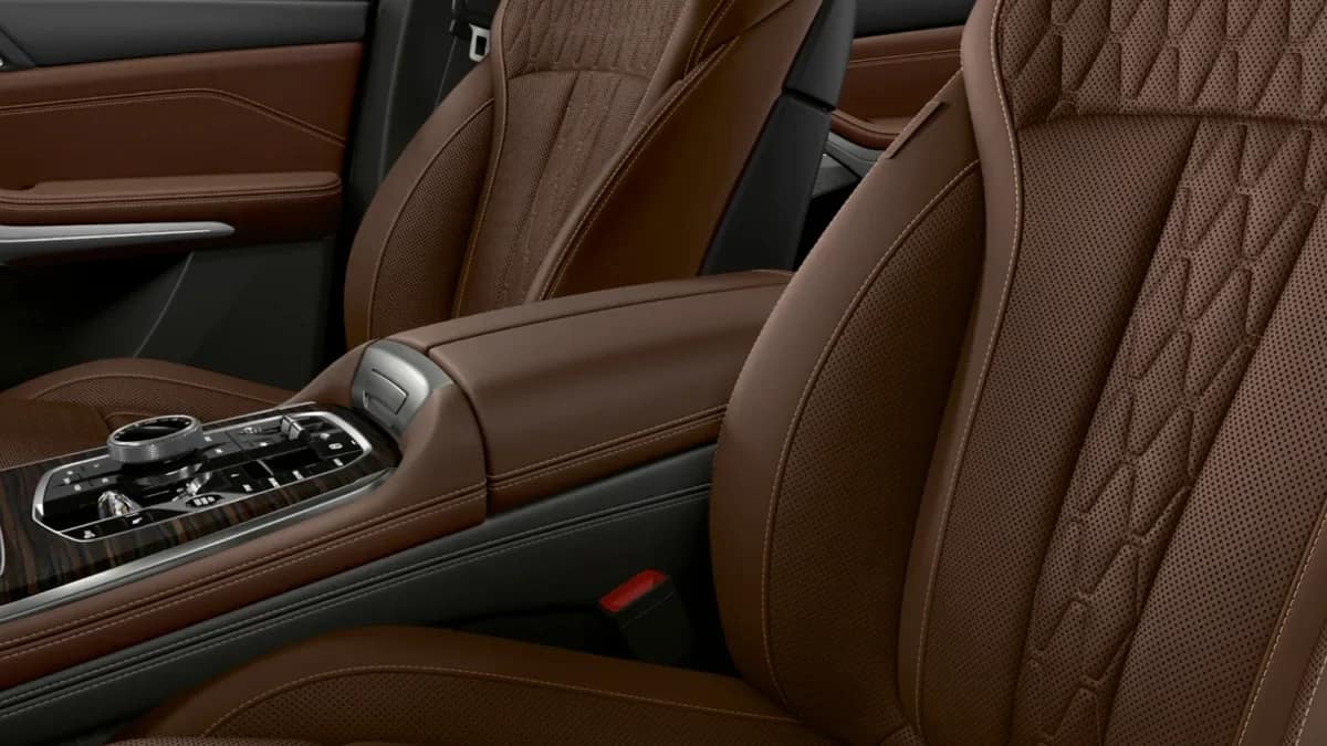 Brown quilted front seats of the BMW X5 seen from the open driver door