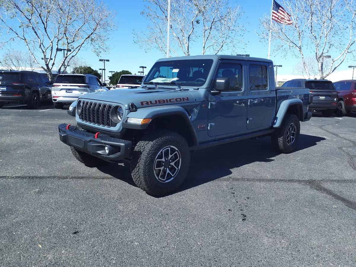 Grey 2024 Jeep Gladiator Rubicon X pickup parked at a US dealership