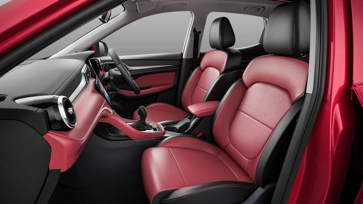 MG Astor cabin with red and black leatherette front seats seen through the open door