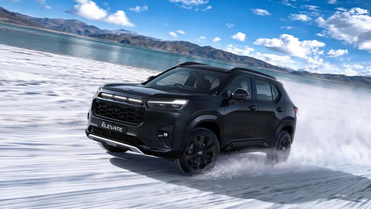 Black 2026 Honda Elevate ZX+ Black edition with gloss black alloy wheels driving on a snowy salt flat