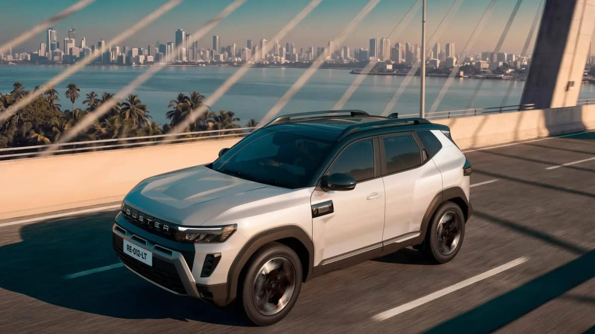 New Renault Duster hybrid in white driving on a bridge, front three-quarter view