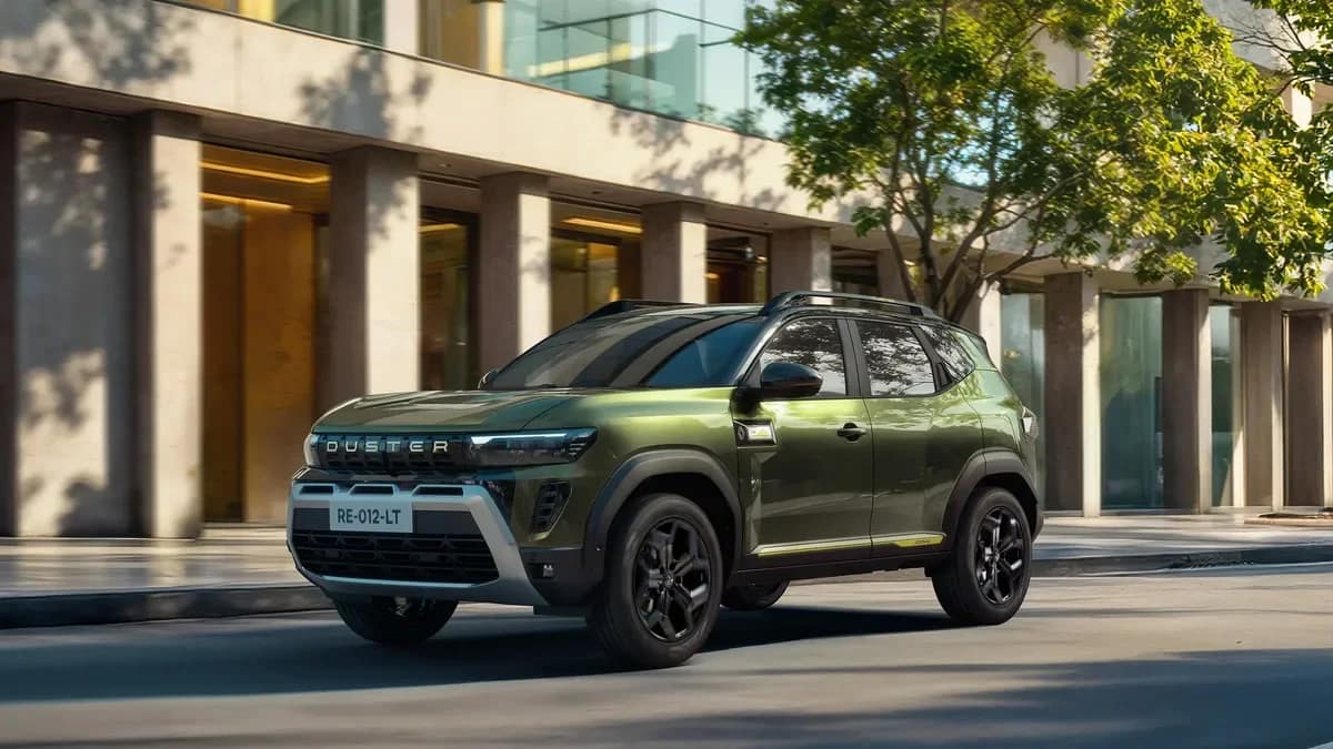Green new Renault Duster driving past a building in the city