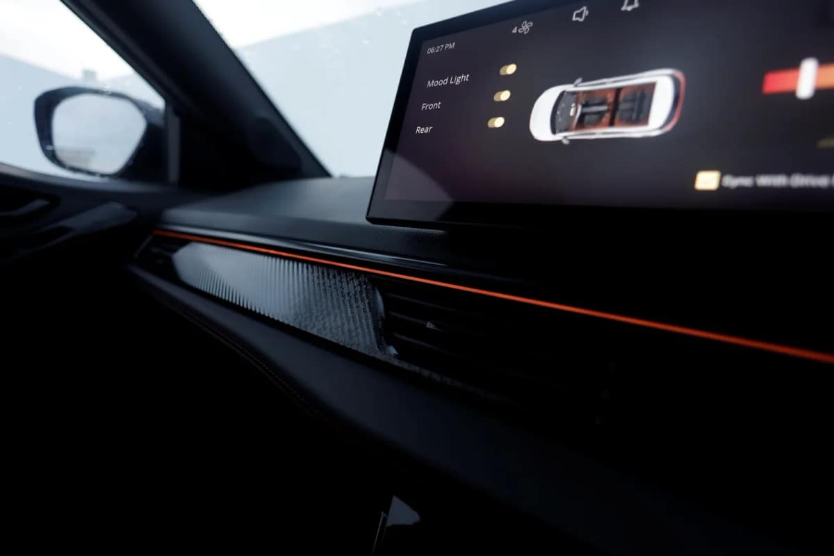 Close view of the Tata Nexon.ev dashboard with orange ambient light strip and touchscreen
