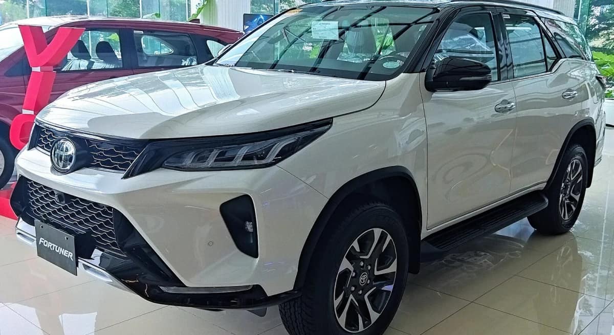 Current Toyota Fortuner in white seen from the front at a showroom